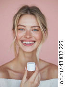 A young woman holds a with moisturizing cream in her beautiful well-groomed hands. Hand and body skin care concept. Close-up. Стоковое AI-изображение, AI-художник Ирина Ручушкина / Фотобанк Лори