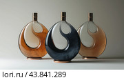 Elegant Triad of Glass Bottles With Unique Curved Designs on Display. Стоковое AI-изображение, AI-художник Сергей Толмачёв / Фотобанк Лори
