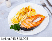 Grilled salmon steak served on plate with fried potato. Стоковое фото, фотограф Яков Филимонов / Фотобанк Лори