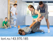 Girl student, with help of male teacher, completes neutralization of opponent. Стоковое фото, фотограф Яков Филимонов / Фотобанк Лори