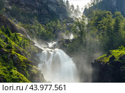 Latefossen is one of the most visited waterfalls in Norway and is located near Skare and Odda in the region Hordaland, Norway. Consists of two separate streams flowing down from the lake Lotevatnet. (2019 год). Стоковое фото, фотограф Андрей Армягов / Фотобанк Лори