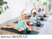 Girl participates in group lesson with softball, modern sport in studio. Стоковое фото, фотограф Яков Филимонов / Фотобанк Лори