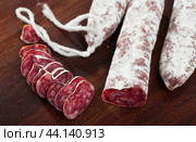 Spanish sausage fuet on a wooden table, closeup. Стоковое фото, фотограф Яков Филимонов / Фотобанк Лори