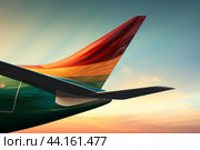 Colorful airplane wing at sunset. Стоковое AI-изображение, AI-художник Иван Рябоконь / Фотобанк Лори
