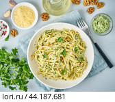 Pesto pasta, bavette with walnuts, parsley, garlic, nuts, olive oil. Top view, close-up. Стоковое фото, фотограф Natalia Gdovskaia / Фотобанк Лори