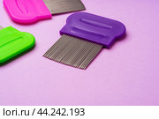 Three combs for removing lice and nits on lilac background. Стоковое фото, фотограф Сергей Толмачёв / Фотобанк Лори