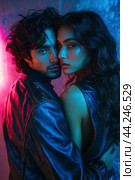 Young couple poses intimately with colorful lighting in an urban setting at night. Стоковое AI-изображение, AI-художник Юлия Гапеенко / Фотобанк Лори