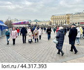 Люди гуляют по Манежной площади на фоне Моховой улицы в Москве. Редакционное фото, фотограф Овчинникова Ирина / Фотобанк Лори