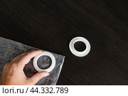 Installing eyelets in curtain, cutting out a hole for the grommet with scissors. Стоковое фото, фотограф Наталья Симакова / Фотобанк Лори