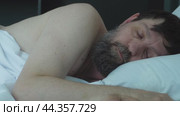 A bearded man is sleeping in bed. The concept sleep. Стоковое видео, видеограф Ярославский Максим / Фотобанк Лори