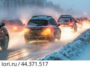 Heavy traffic in suburbs during storm, rear view. Стоковое AI-изображение, AI-художник Владимир Григорьев / Фотобанк Лори