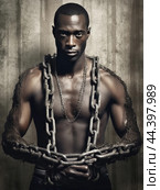 Juneteenth, a day for freedom - African man prisoner in chain slavery concept. Стоковое AI-изображение, AI-художник Veniamin Kraskov / Фотобанк Лори