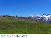 Panoramic mountain landscape with alpine meadow, observatory in the distance and mountain peaks in the background. Стоковое фото, фотограф Евгений Харитонов / Фотобанк Лори