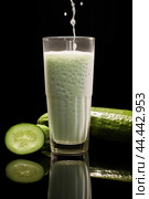 Glass of milk with fresh cucumber. Стоковое AI-изображение, AI-художник Veniamin Kraskov / Фотобанк Лори