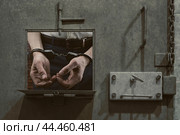 Men's dirty hands in handcuffs. Arrested person. Стоковое фото, фотограф Дмитрий Кобзев / Фотобанк Лори