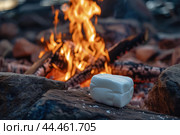 Single marshmallow ready to be roasted by a warming campfire during a quiet evening. Стоковое AI-изображение, AI-художник Иван Рябоконь / Фотобанк Лори