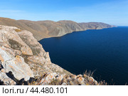 Baikal Lake on Autumn sunny windy day. View from coastal rock to treeless rocky shore of western coast of lake on October. Traveling and hiking along Tazheran steppe and Baikal lake shore. Стоковое фото, фотограф Виктория Катьянова / Фотобанк Лори