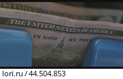 A close-up view of US dollar bills being counted in a cash register. Стоковое видео, видеограф Сергей Толмачёв / Фотобанк Лори