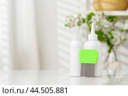 Bottles of Lice Treatment Products and a Comb on a Countertop. Стоковое фото, фотограф Сергей Толмачёв / Фотобанк Лори