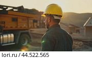 A construction worker oversees the loading of machines at a construction site. Стоковое AI-видео, аниматор Юрий Поздников / Фотобанк Лори