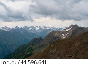 View of the Great Caucasian Ridge opening from the Upper station of the cable car system of the Dombay ski resort on a summer day, Karachay-Cherkessia, Russia. Стоковое фото, фотограф Ula Ulachka / Фотобанк Лори