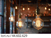 Vintage edison light bulbs in modern interior. Стоковое AI-изображение, AI-художник Иван Рябоконь / Фотобанк Лори