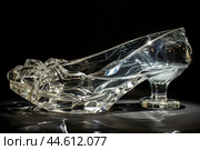 Crystal glass slipper on black background. Стоковое AI-изображение, AI-художник Иван Рябоконь / Фотобанк Лори