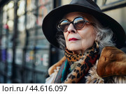 Elegant senior lady with sunglasses and hat outdoors. Стоковое AI-изображение, AI-художник Иван Рябоконь / Фотобанк Лори