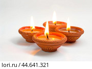 Traditional clay diya lamps lit for diwali festival. Стоковое AI-изображение, AI-художник Иван Рябоконь / Фотобанк Лори