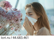 Young woman is suffering from a pollen allergy and sneezing. Стоковое AI-изображение, AI-художник Иван Рябоконь / Фотобанк Лори