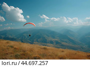 Paraglider flying over mountain valley on sunny day. Стоковое AI-изображение, AI-художник Иван Рябоконь / Фотобанк Лори