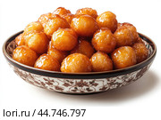 Delicious Tatar chak-chak served on a plate isolated on a white background. Стоковое AI-изображение, AI-художник Veniamin Kraskov / Фотобанк Лори