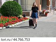 Female dragging a suitcase to leave the room on vacation, Travel and life style concept, rear view. Стоковое фото, фотограф Вербицкая Светлана / Фотобанк Лори