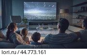 Family relaxing together on sofa watching movie on tv at night. Стоковое AI-видео, аниматор Юрий Поздников / Фотобанк Лори