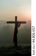 Wooden cross with red fabric in foggy background, concept of spirituality. Стоковое AI-изображение, AI-художник Анастасия Золотницкая / Фотобанк Лори