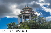 Beautiful pagoda of a Chinese temple against a blue sky, clouds. A tiered roof with curved edges, ornaments on the walls and columns. The spires are on top. Malaysia. Penang. Kek Lok Si Temple (2023 год). Стоковое фото, фотограф Вера Ивановна Кубарева / Фотобанк Лори