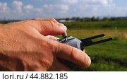 a surveyor on a construction site controls a quadcopter. Стоковое видео, видеограф Igor Skripachev / Фотобанк Лори