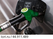 The gas station. Filling the car with gasoline. A Russian fuel dispenser in the fuel tank of a car at a gas station. Rising fuel prices around the world. Стоковое фото, фотограф Photojuli / Фотобанк Лори