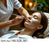 The beautician applies a cleansing clay mask to the girl's face while she lies in the chair. It gently exfoliates dead cells, smoothes the texture and evens out the tone. Стоковое AI-изображение, AI-художник Сергей Елизарьев / Фотобанк Лори