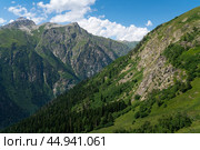 View of Mount Semenov-Bashi of the Greater Caucasus Range from the upper station of the cable car of the Dombai ski resort on a summer day, Karachay-Cherkessia, Russia. Стоковое фото, фотограф Ula Ulachka / Фотобанк Лори