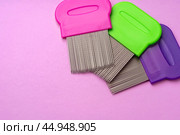 Three combs for removing lice and nits on lilac background. Стоковое фото, фотограф Сергей Толмачёв / Фотобанк Лори