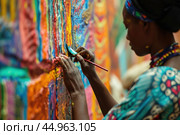 A woman artist creating a vibrant mural that pays homage to African culture and history. Стоковое AI-изображение, AI-художник Veniamin Kraskov / Фотобанк Лори