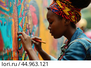 A woman artist creating a vibrant mural that pays homage to African culture and history. Стоковое AI-изображение, AI-художник Veniamin Kraskov / Фотобанк Лори