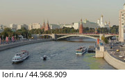 Москва. Вид с Патриаршего моста на Кремль и Большой Каменный мост. По Москве-реке проплывают речные прогулочные теплоходы. Теплое вечернее солнечное освещение. Лето. Редакционное видео, видеограф Сергей Никифоров-Гордеев / Фотобанк Лори