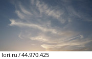 Cirrus Ci is genus of high cloud made of ice crystals, appear delicate wispy white strands. Cirrus formed when warm dry air rises, water vapor deposition onto dust particles at high altitudes. Стоковое видео, видеограф Юлия Петровская / Фотобанк Лори