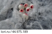 Six gouged out human eyeballs lie in a thick web. A strong wind blows the web. Halloween, horror, nightmare. Return of evil. Human eyeballs in web. Red blood vessels and veins. Human parts and organs. Стоковое видео, видеограф Юлия Петровская / Фотобанк Лори