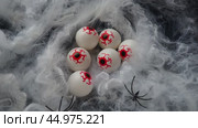 Six gouged out human eyeballs lie in a thick web. A strong wind blows the web. Halloween, horror, nightmares. Return of evil. Human eyeballs in web. Red blood vessels and veins. Human parts and organs. Стоковое видео, видеограф Юлия Петровская / Фотобанк Лори