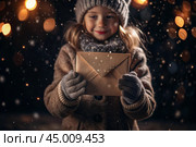 A little girl in winter clothes holding an envelope outside in snowy weather against the background of lights. A letter for Santa Claus. The winter atmosphere of a festive invitation. Стоковое AI-изображение, AI-художник Photojuli / Фотобанк Лори