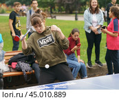 Moscow, Russia - September 5, 2019: Photography of sports competitions in the Gorky park. Young woman playing ping-pong in summer day.  Healthy lifestyles of youth. Редакционное фото, фотограф YuryKara / Фотобанк Лори