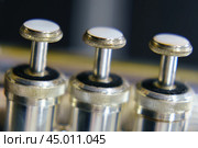 The silver trumpet pipe valves on the defocused background. Musical instrument photography. Стоковое фото, фотограф YuryKara / Фотобанк Лори